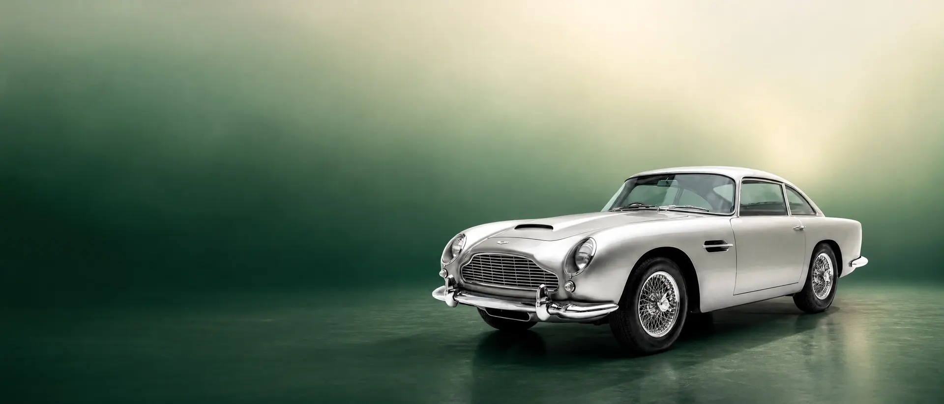 Aston Martin DB4 staged in a darkened scene