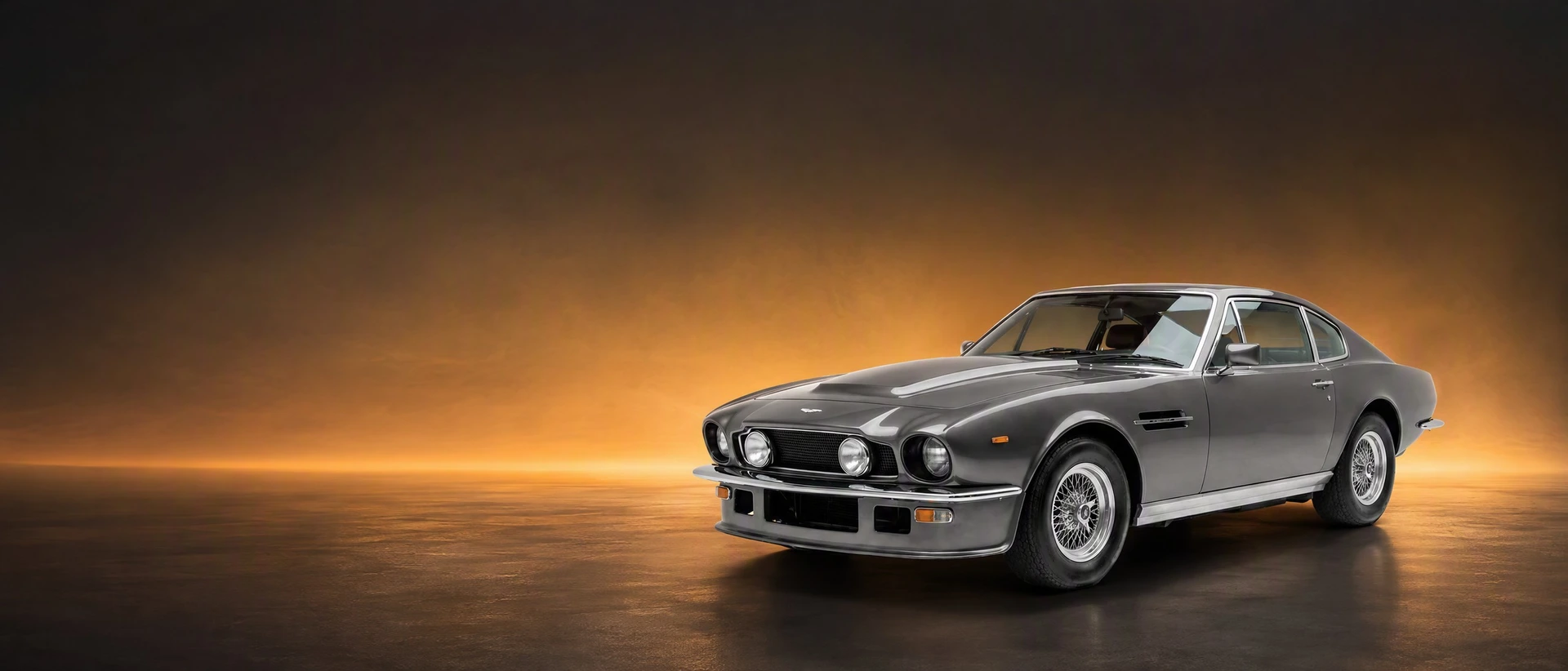 An Aston Martin V8 Vantage, front three-quarter view on a charcoal-amber field