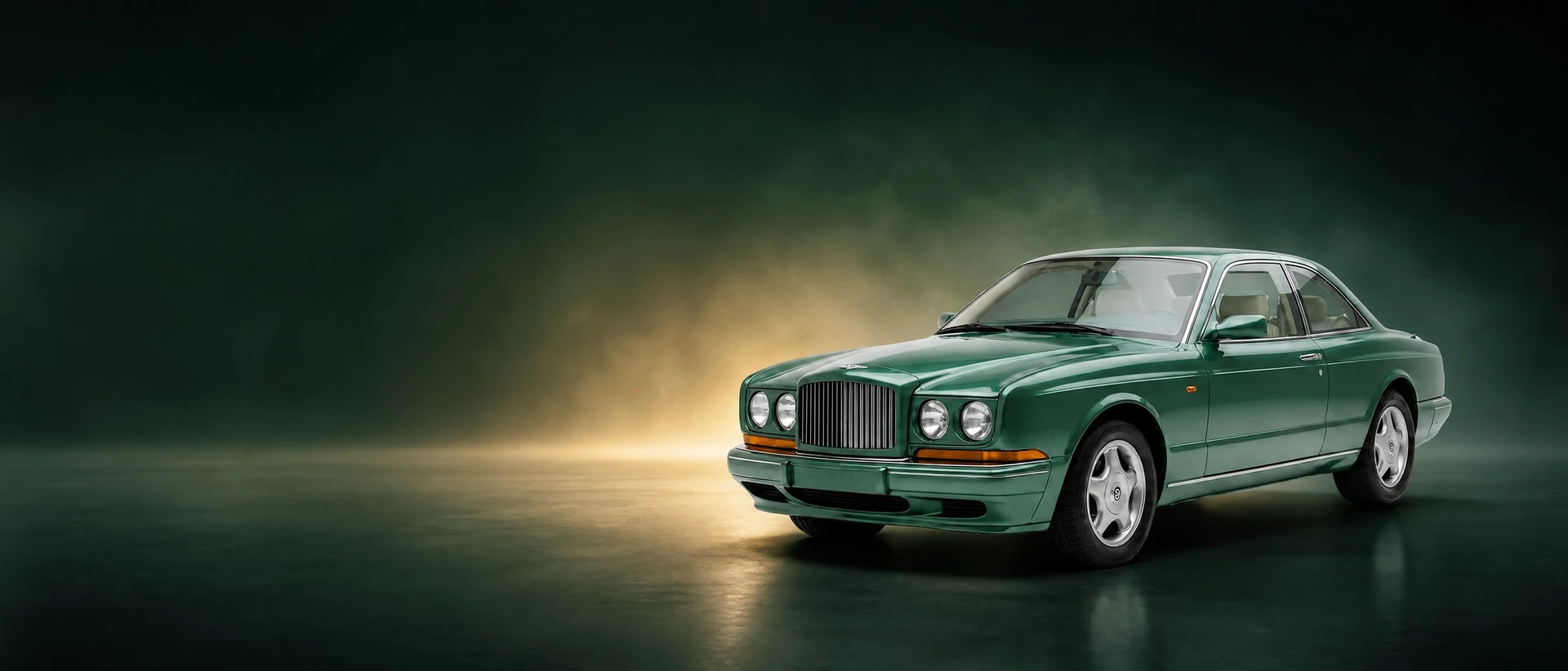 A Bentley Continental R, front three-quarter view on a bottle-green field with a warm glow