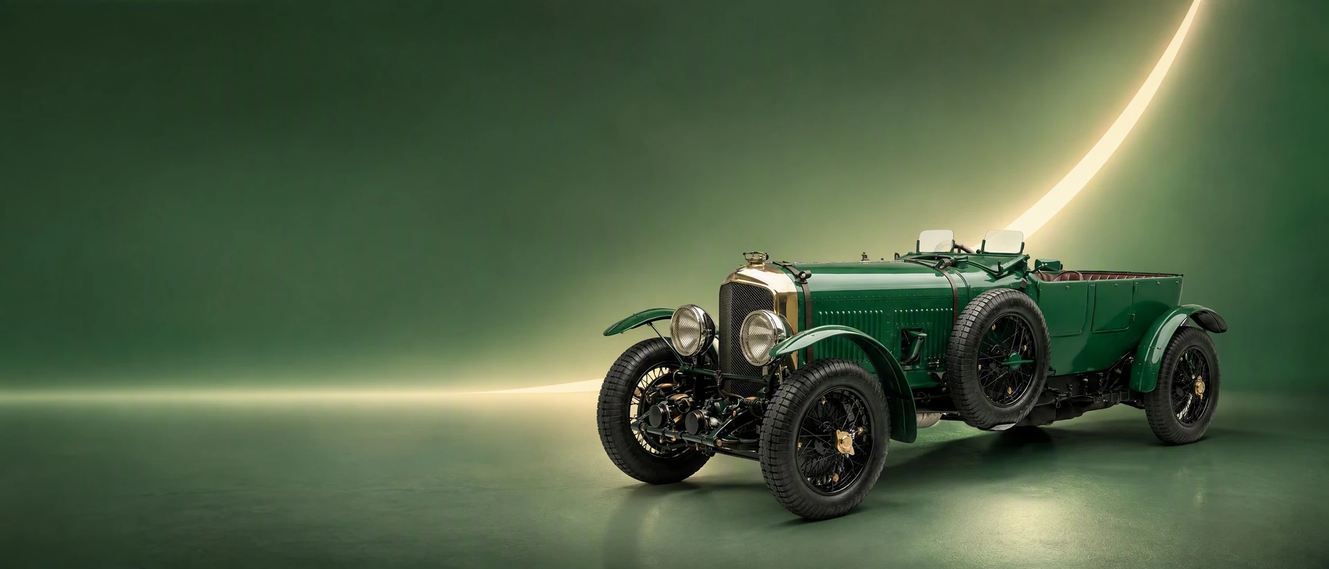 A green Bentley Speed Six, front three-quarter view on a racing-green field with a warm arc