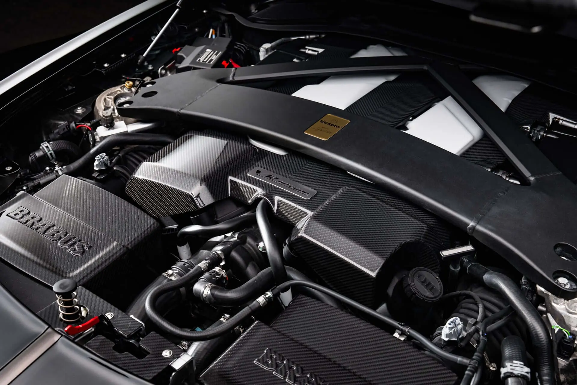 Brabus Bodo engine bay with carbon-covered 5.2-litre V12 biturbo and gold Masterpiece plaque