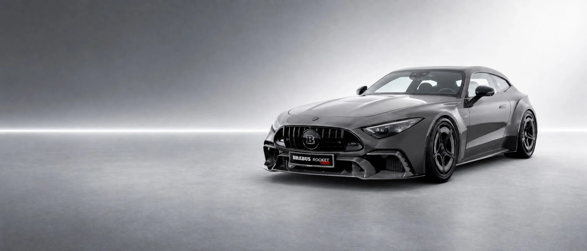 Brabus Rocket GTS in exposed anthracite carbon, front three-quarter view on a cool platinum stage with a silver seam of light