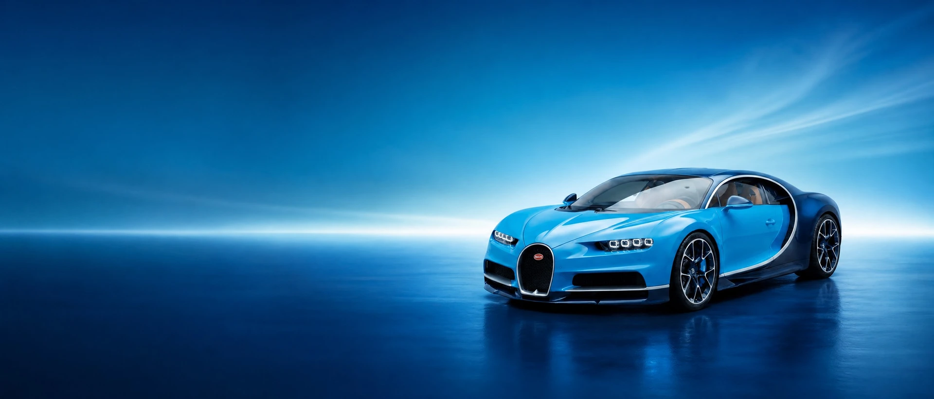 A blue Bugatti Chiron, front three-quarter view on a two-tone blue field with a light bloom