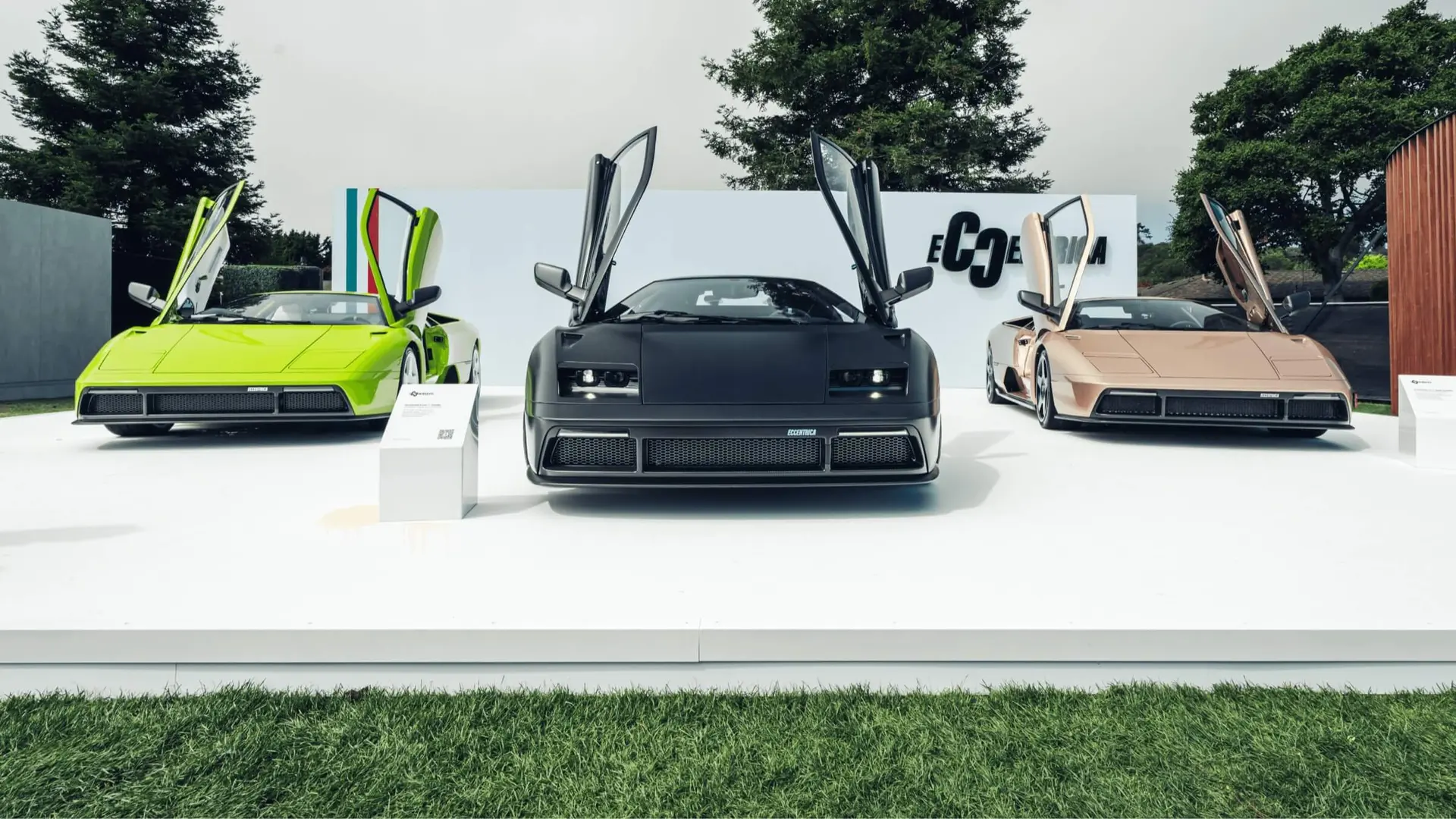 Green Dragon, Titano and Rose Phoenix Eccentrica V12s side by side on the stand at The Quail 2025