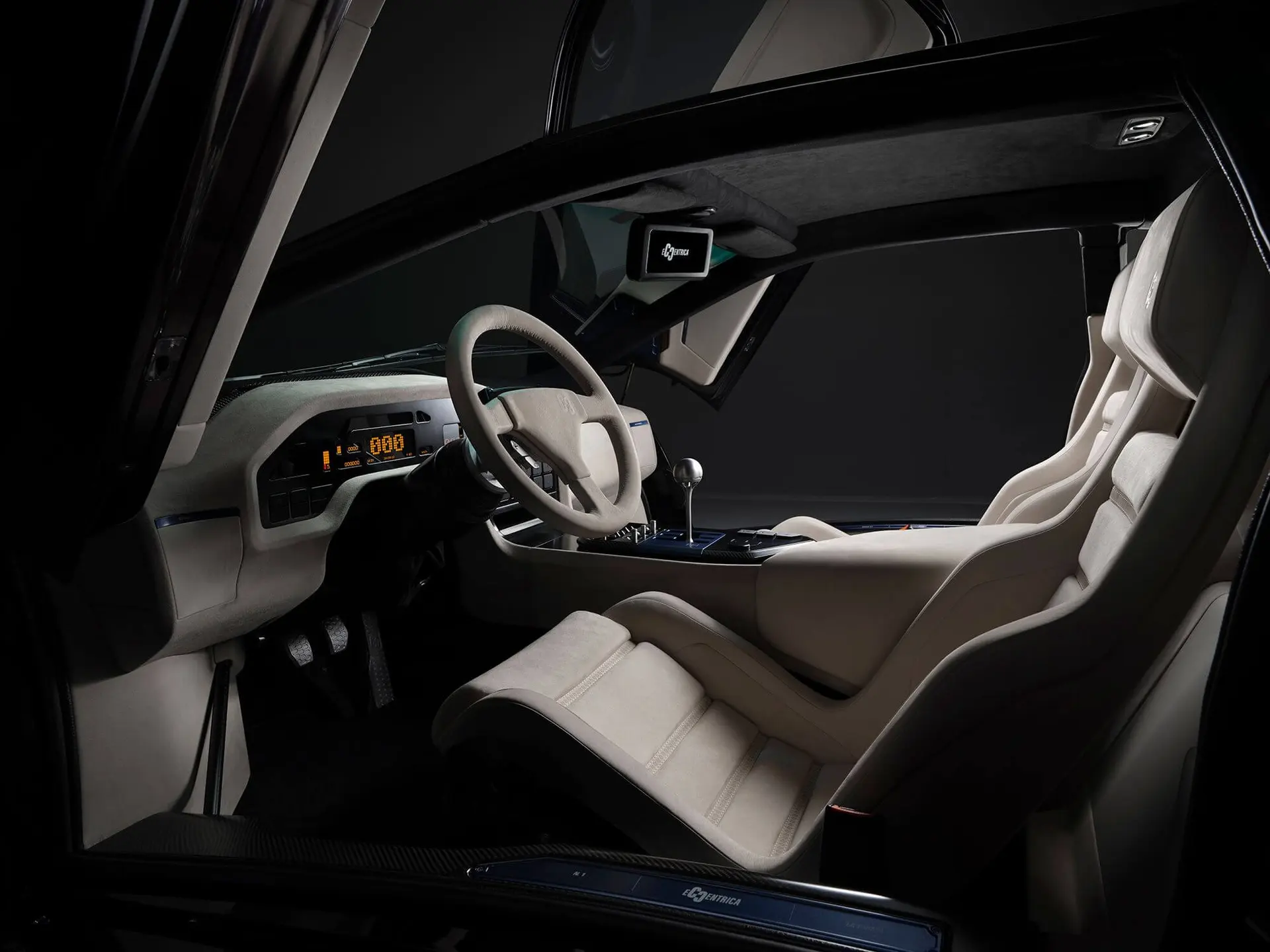 Eccentrica V12 interior with pale Alcantara seats, exposed gated shifter and digital instrument display