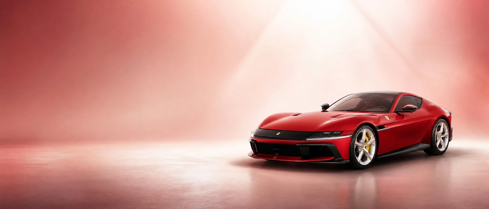 A red Ferrari 12Cilindri berlinetta, front three-quarter view on a warm white field with a skylight beam