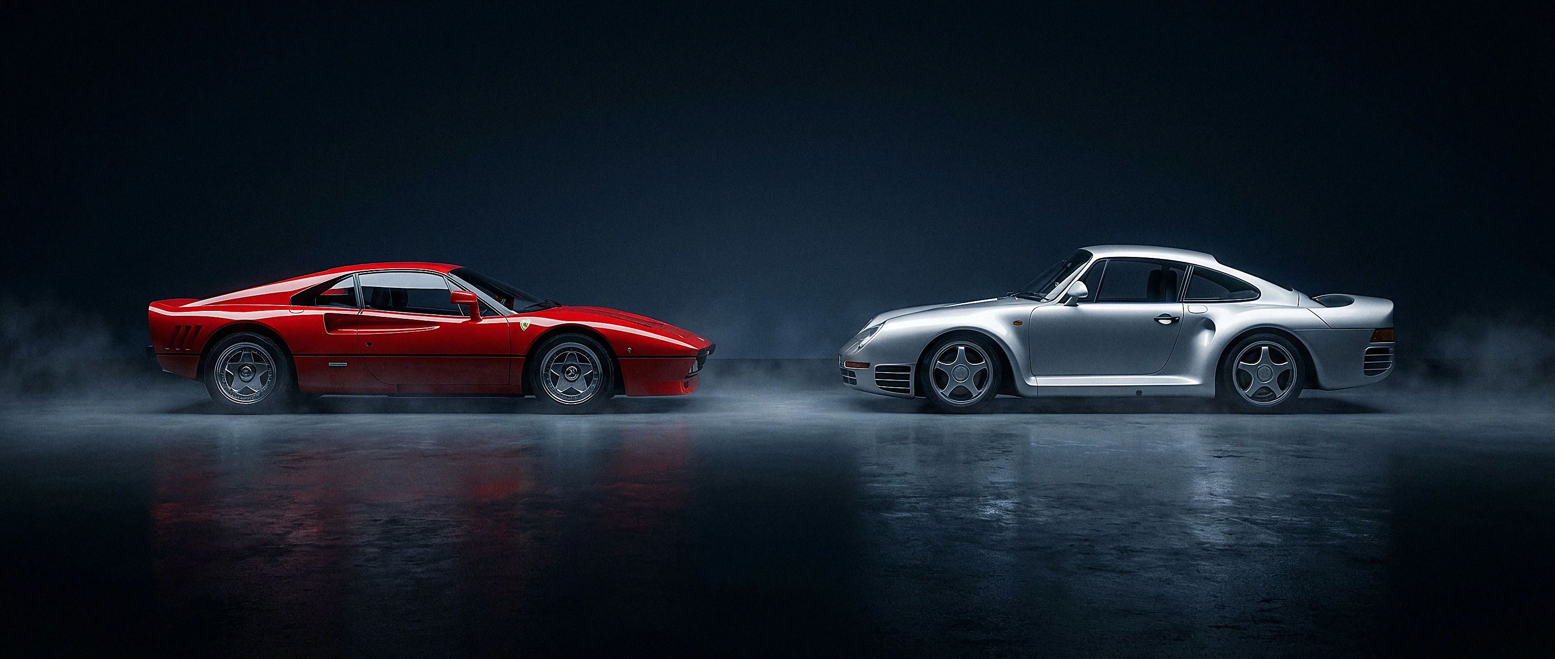 Ferrari 288 GTO and Porsche 959 facing one another across a dark stage