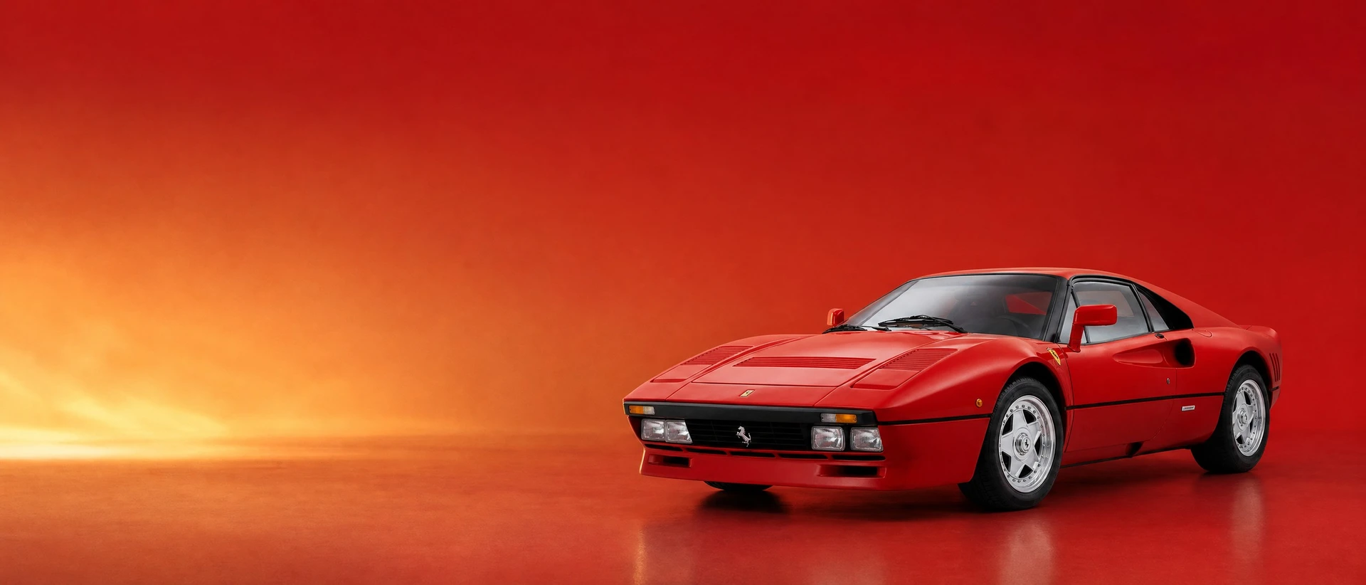 A red Ferrari 288 GTO, front three-quarter view on a rosso field with rising golden haze