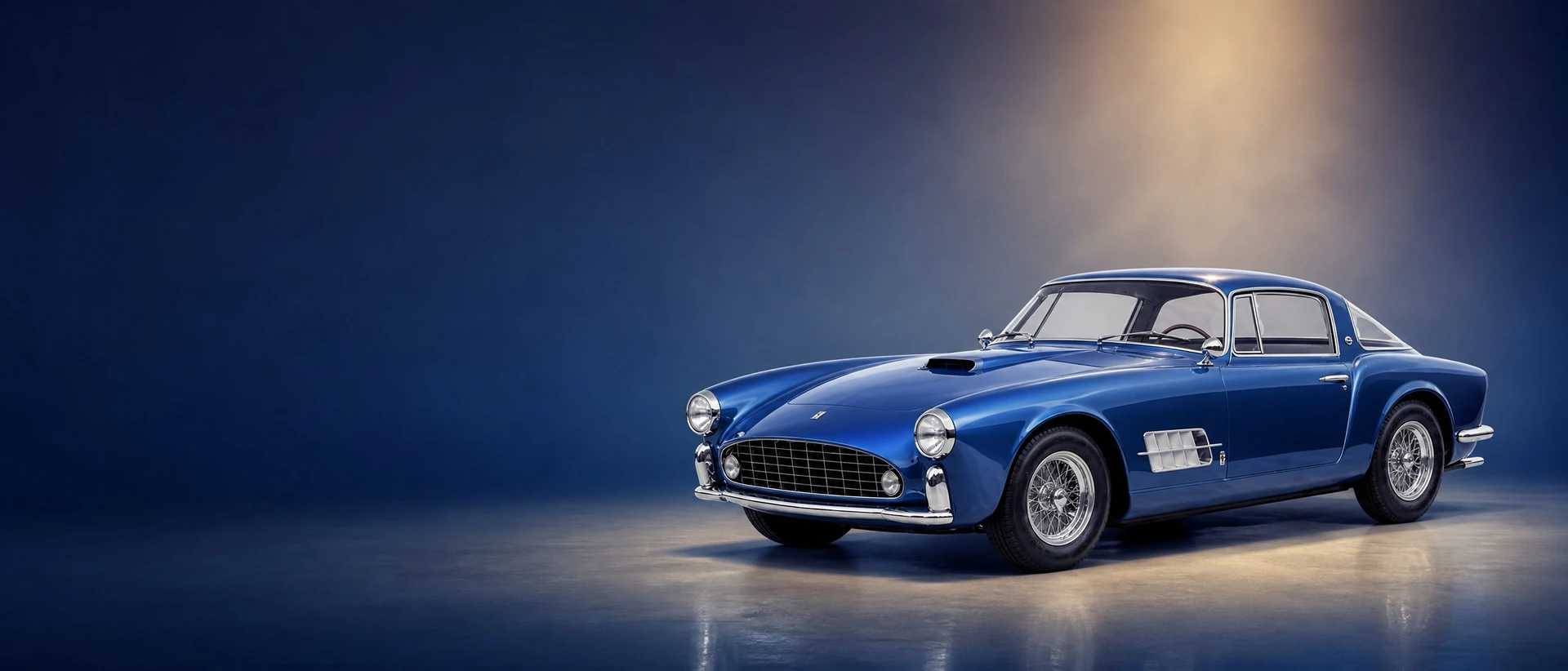 A blue metallic Ferrari Superamerica, front three-quarter view on a deep-blue field with a tailored spotlight