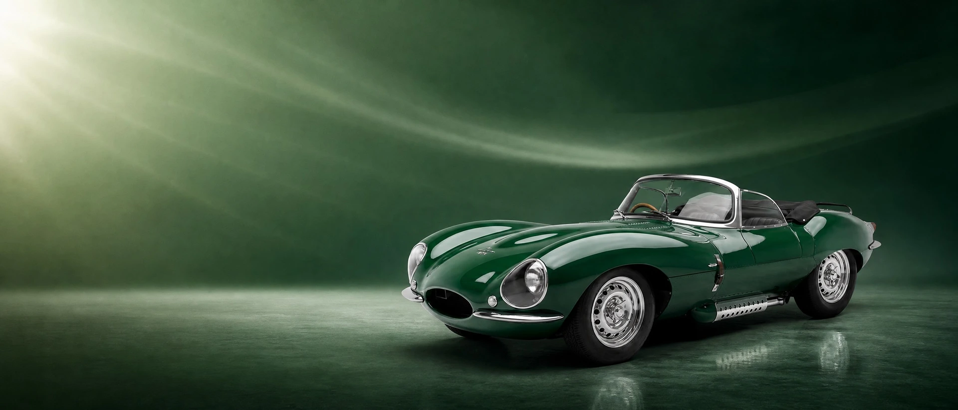 A British Racing Green Jaguar XKSS, front three-quarter view on a fresh green field with washed light