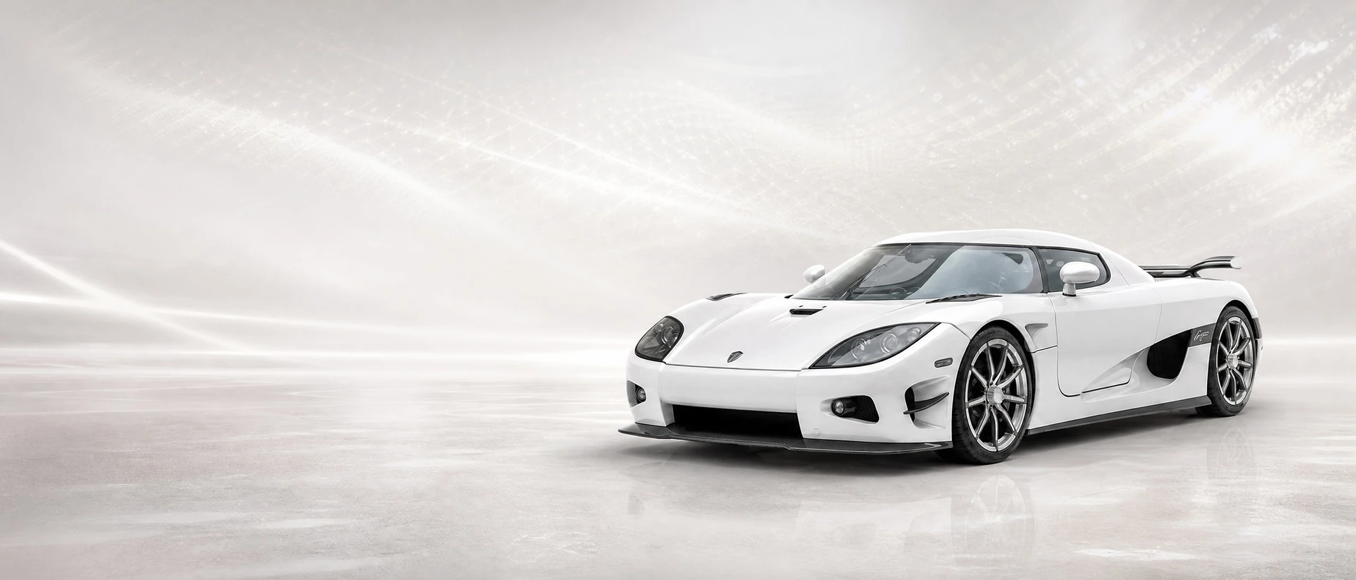 A silver-white carbon Koenigsegg CCXR Trevita, front three-quarter view on a white field with diamond shimmer
