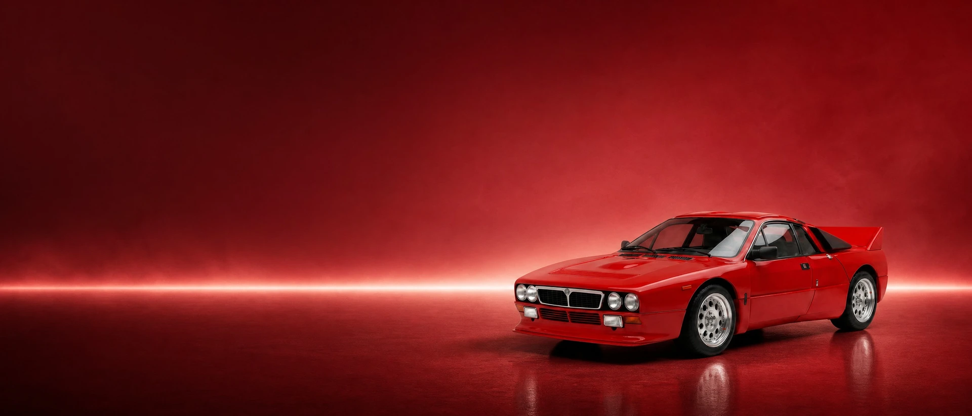 A red Lancia Rally 037 Stradale, front three-quarter view on a deep rosso field with one white blade of light