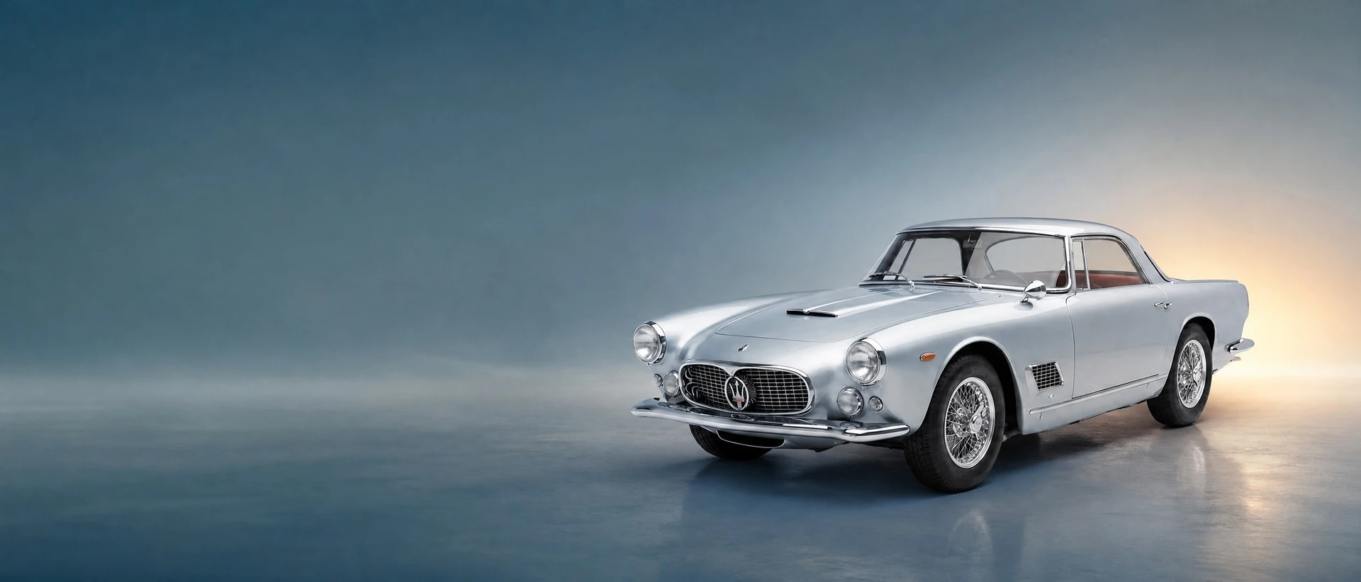 A Maserati 3500 GT, front three-quarter view on a petrol-blue field with a warm glow