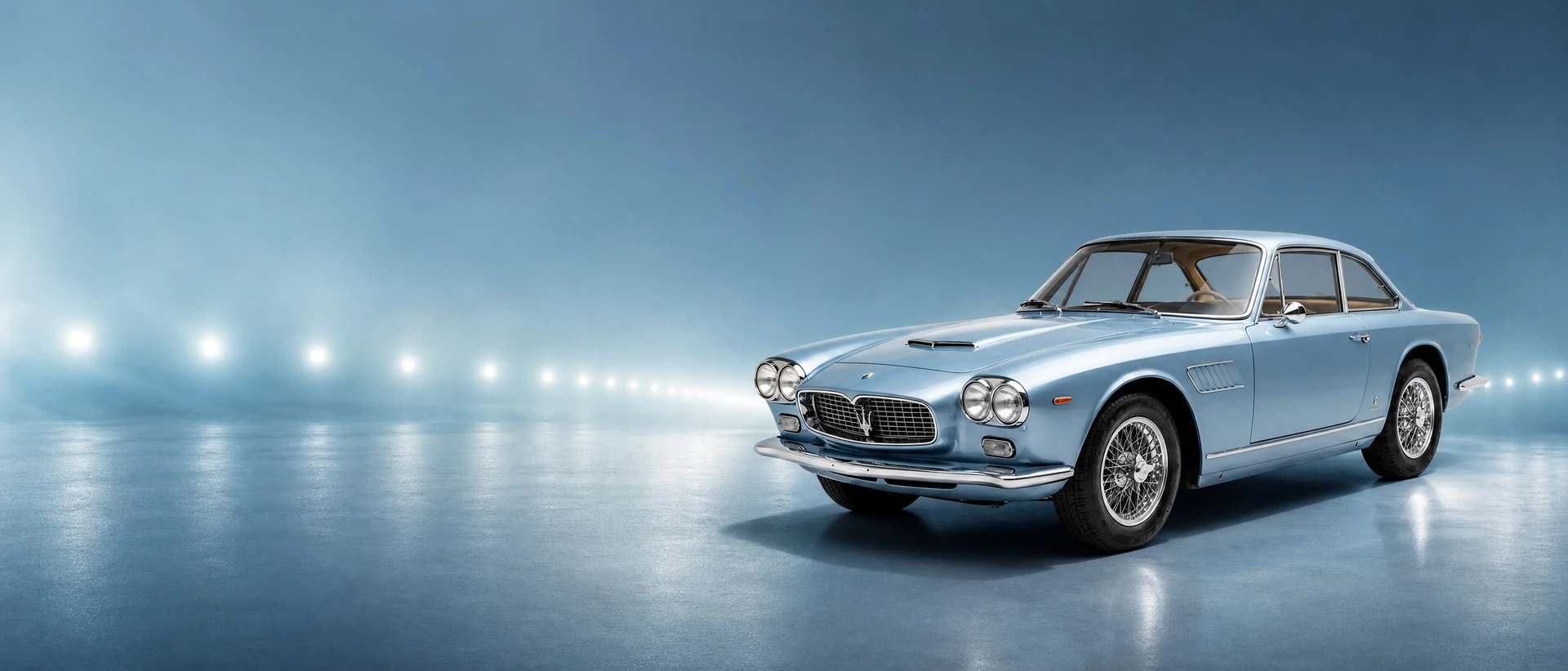 A blue Maserati Sebring by Vignale, front three-quarter view on a steel-blue field with beacon points