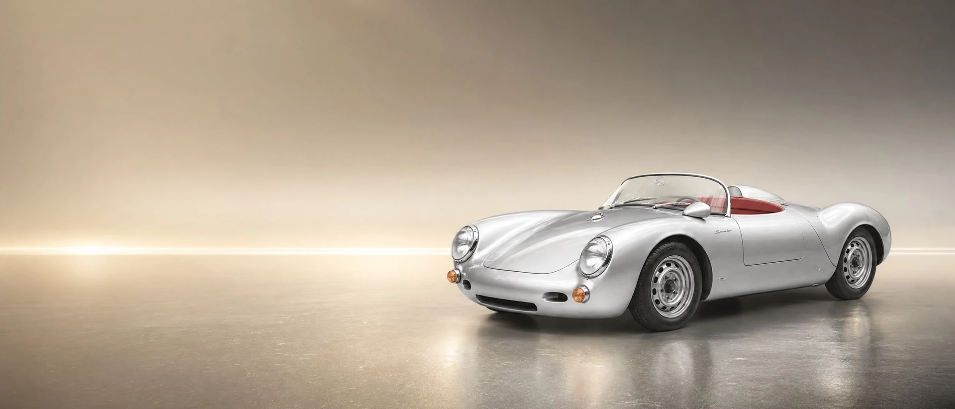 A silver Porsche 550 Spyder, front three-quarter view on a golden field with a long light line