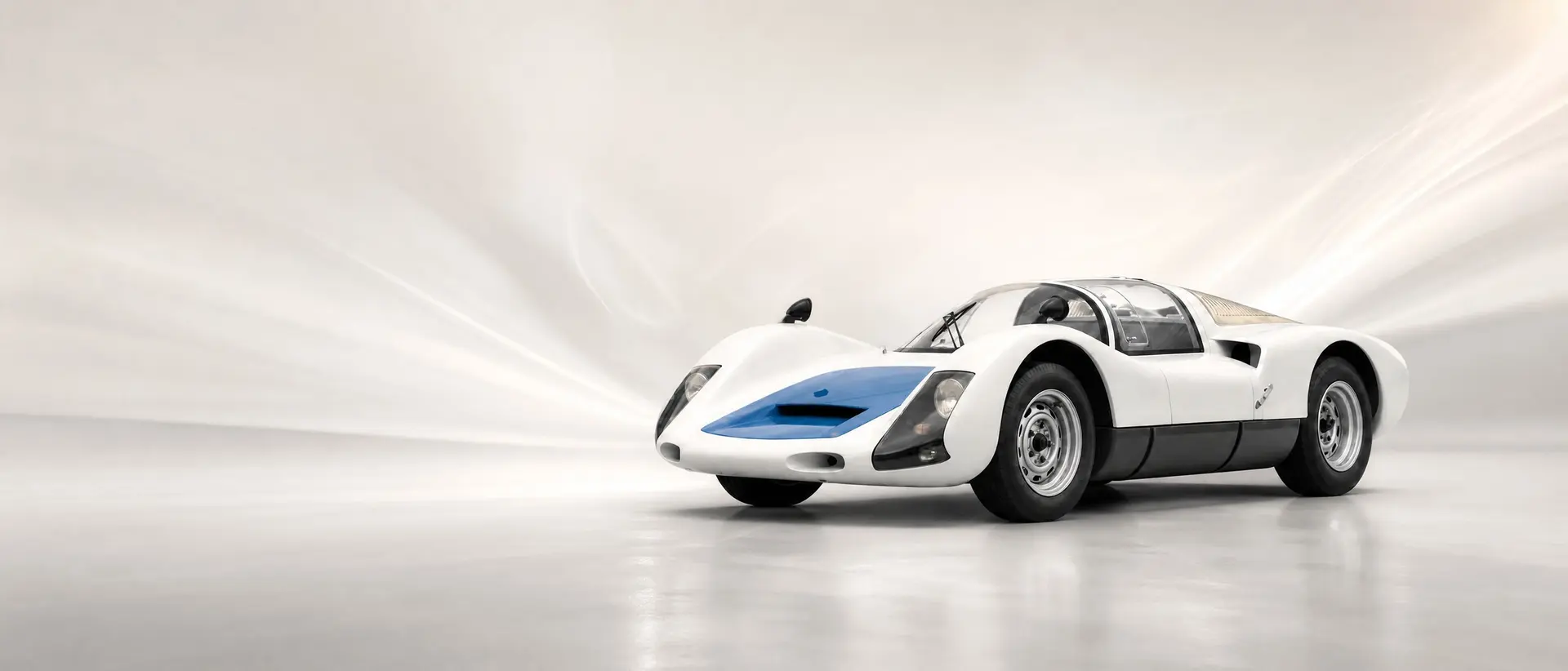 Porsche 906 Carrera 6 staged in a darkened scene