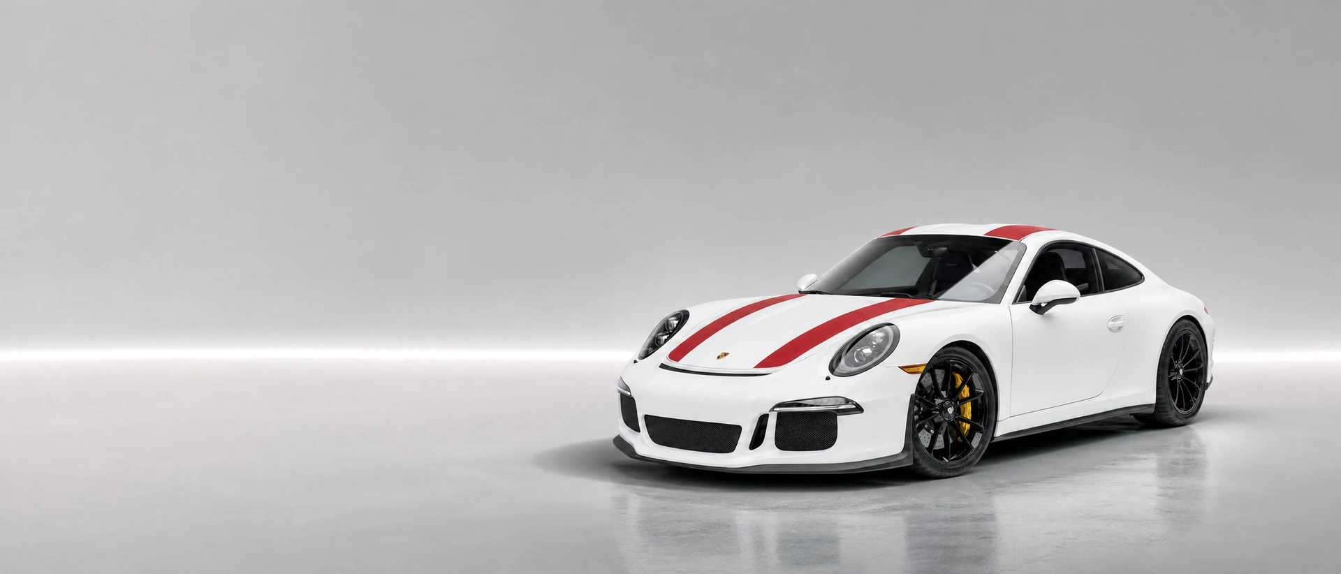A white Porsche 911 R with red stripes, front three-quarter view on a pale field with a needle of light