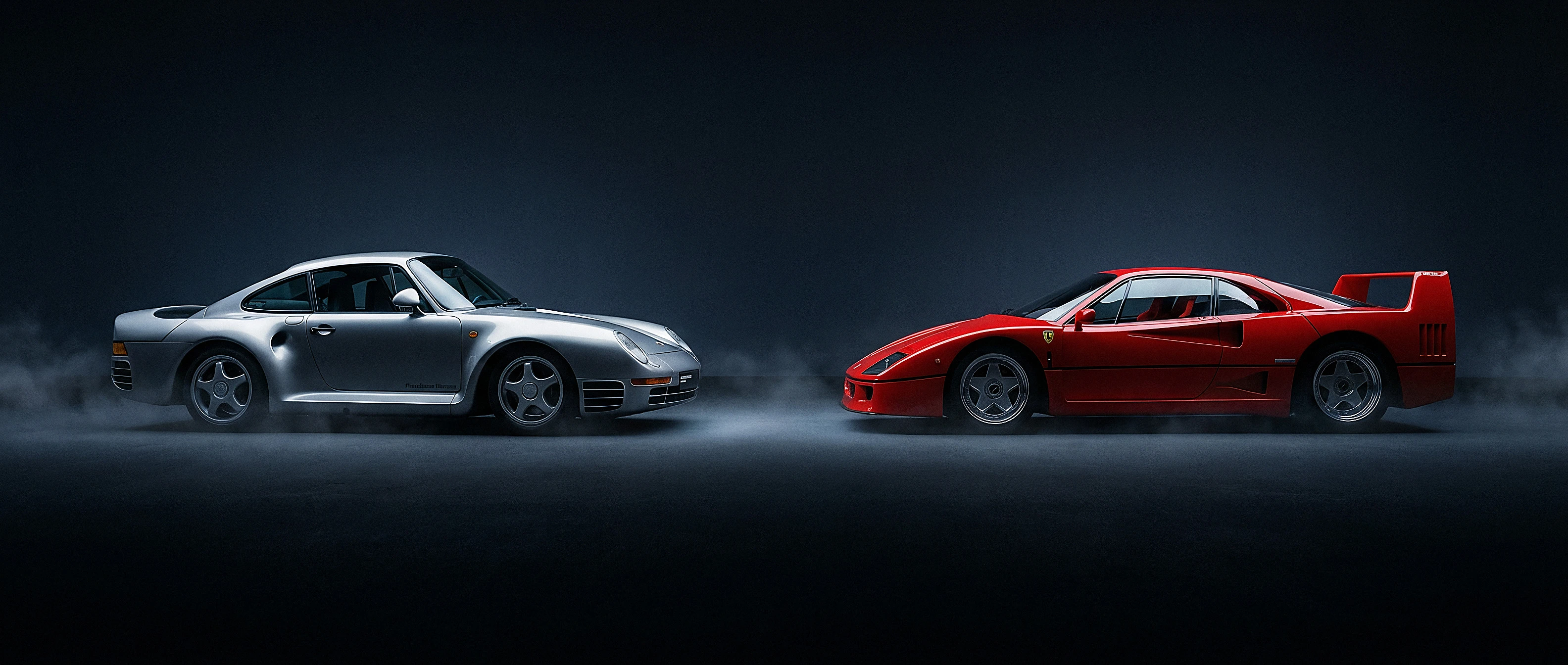 Silver Porsche 959 and red Ferrari F40 nose to nose across a dark technical stage