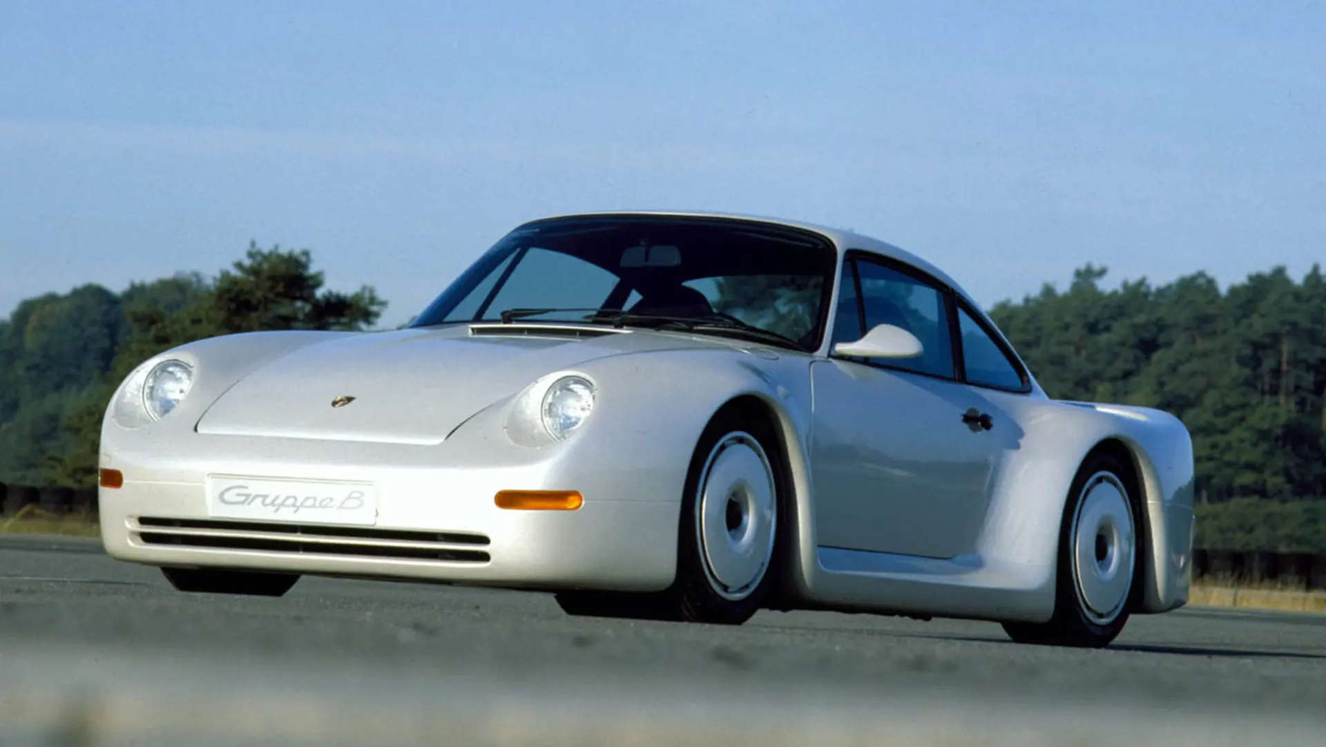 White Porsche Gruppe B study driving on an outdoor test track