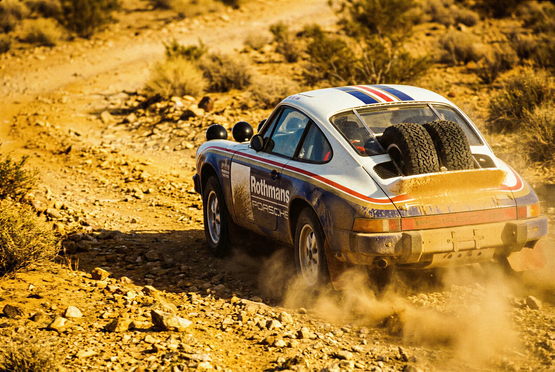 Editorial artwork of a Porsche Type 953 on a desert rally stage