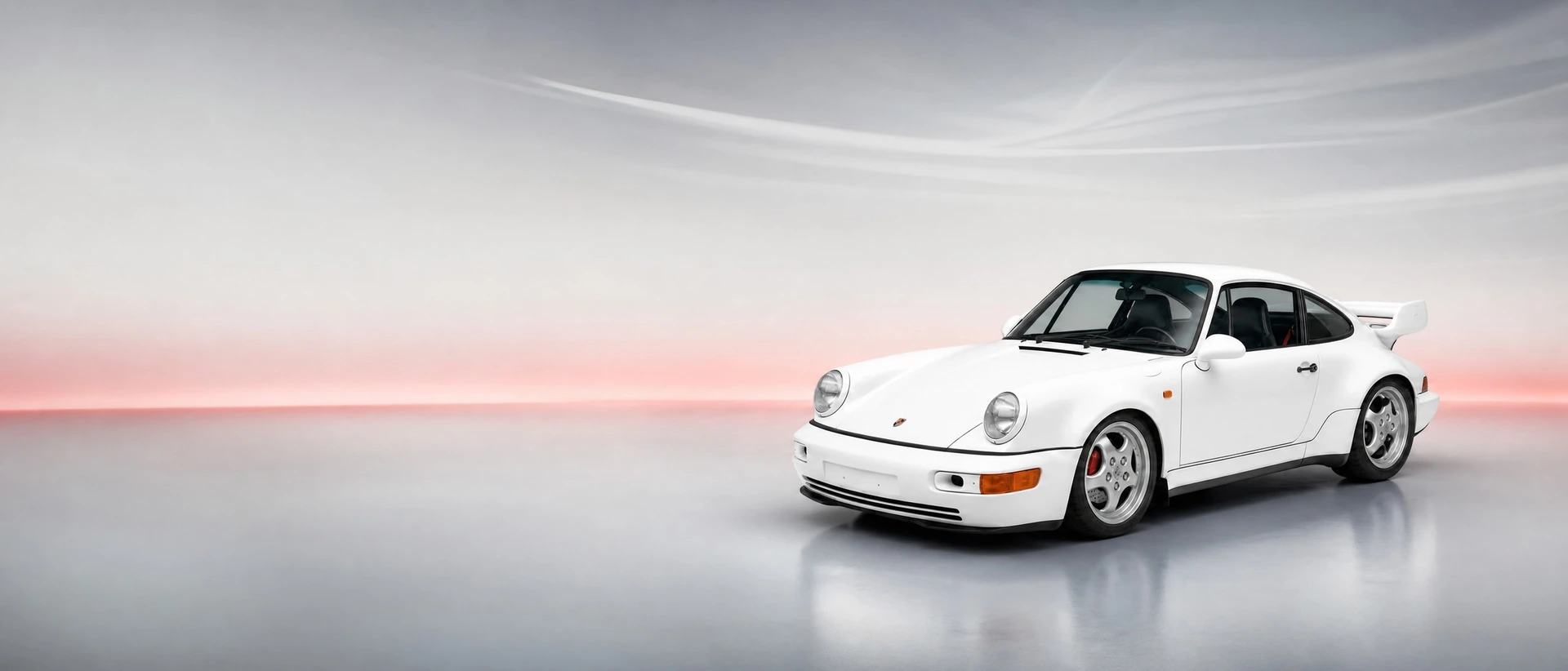 A Porsche 964 Carrera RS, front three-quarter view on a silver field with a rubystone glow