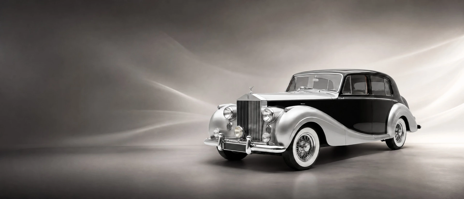 A Rolls-Royce Silver Wraith coachbuilt saloon, front three-quarter view on a charcoal field with lifting mist